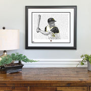 Matted and framed wall word art portrait of Pittsburgh Pirate Bill Mazeroski in 1960 World Series on wall over wooden table.