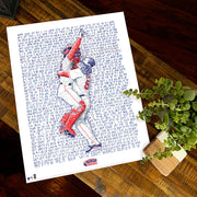 Unframed word art print of Jason Varitek and Jonathan Papelbon of the 2007 Red Sox lies flat on wood table next to plant.