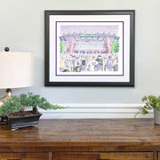 Purple, red, green illustration of front-facing Ravens M&T Stadium and crowd made of words on wall above wood desk.