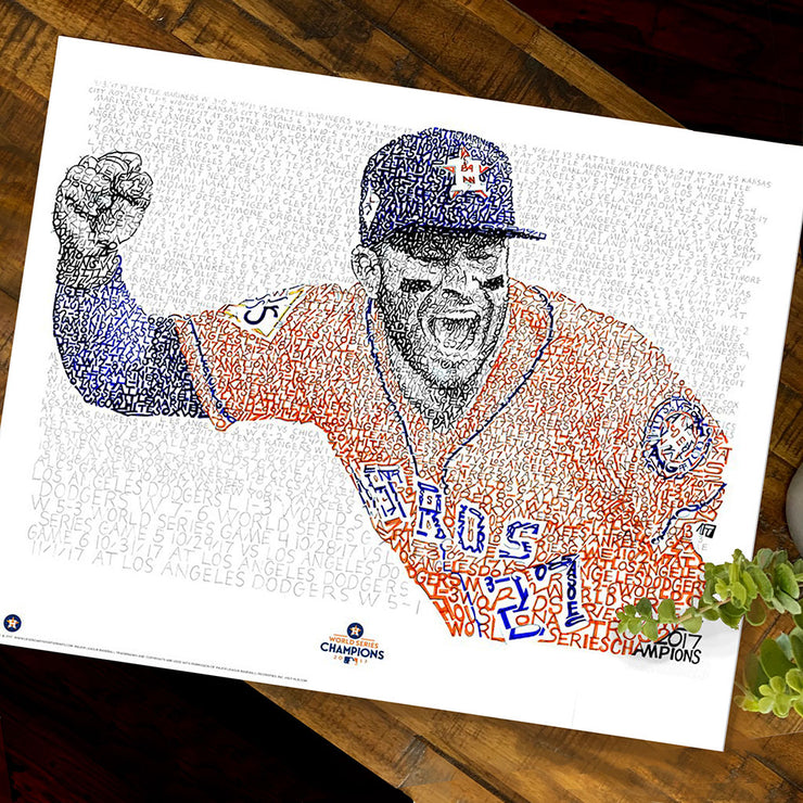 Unframed word art print of Jose Altuve celebrating 2017 Houston Astros World Series winlies flat on wooden table.