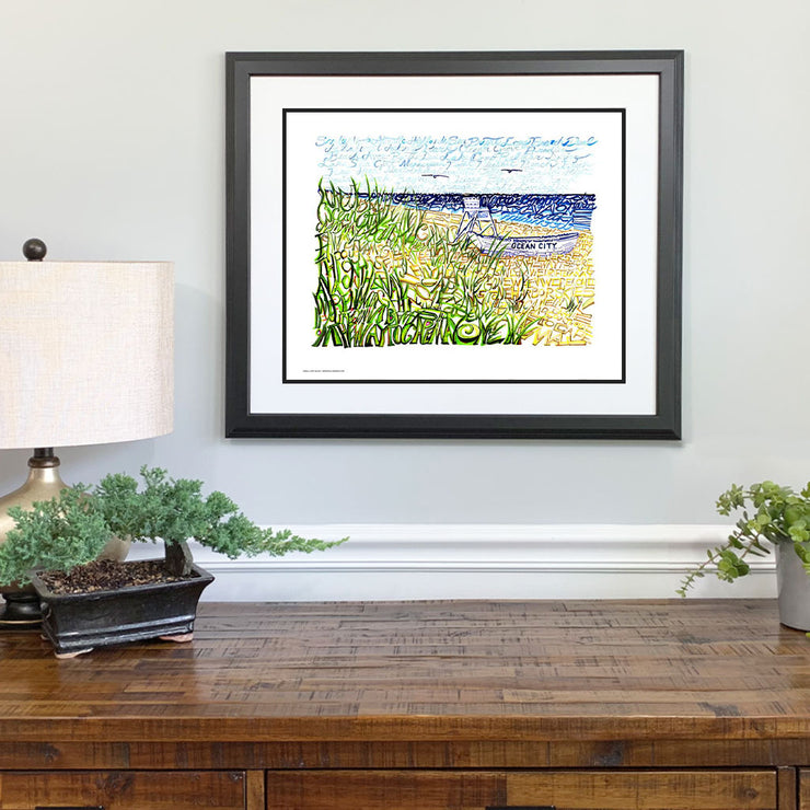 Matted and framed print of Jersey Shore art depicts lifeguard chair and rowboat customizable with destination on its side.