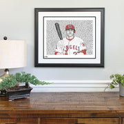 Black, red, white portrait of Angels 2014 MVP Mike Trout wall art with hand-drawn words from his career above wood dresser.