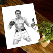 Muhammad Ali art in black and white of boxer fighting made of small hand-written words from his famous speeches on table.