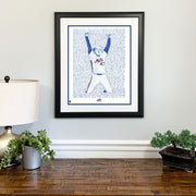 Matted and framed handwritten word art of Jesse Orosco celebrating 1986 World Series win hangs on wall over wood table.