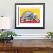 Framed red and yellow artwork of University of Maryland UMD Testudo mascot made of hand drawn lyrics of alma mater on wall.